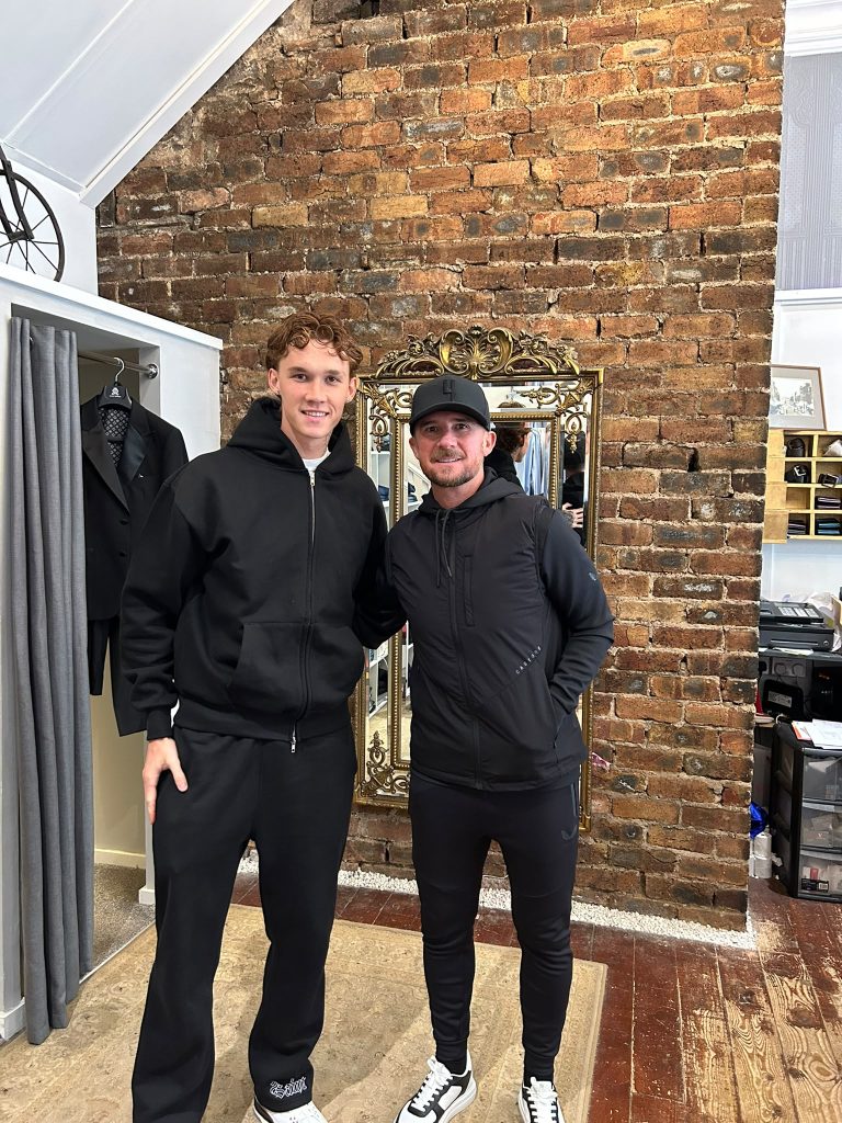 Two customers in black casual outfits in the boutique.