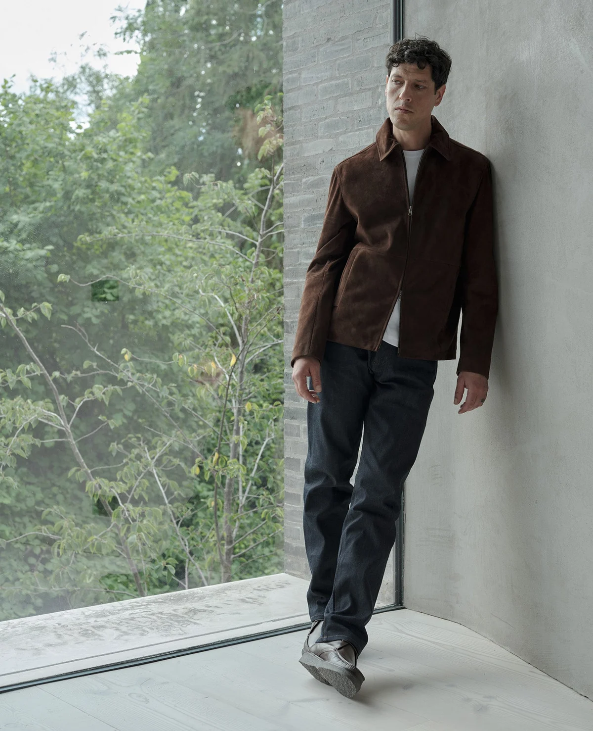Brown zip-front jacket styled with dark trousers