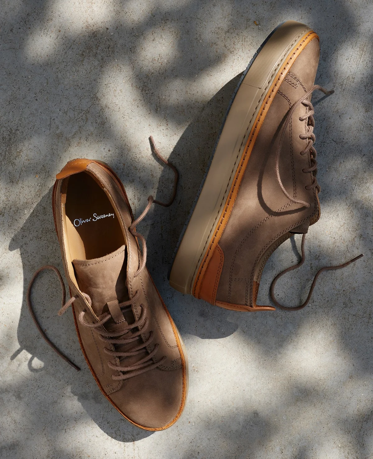 Brown low-top trainers photographed in sunlight