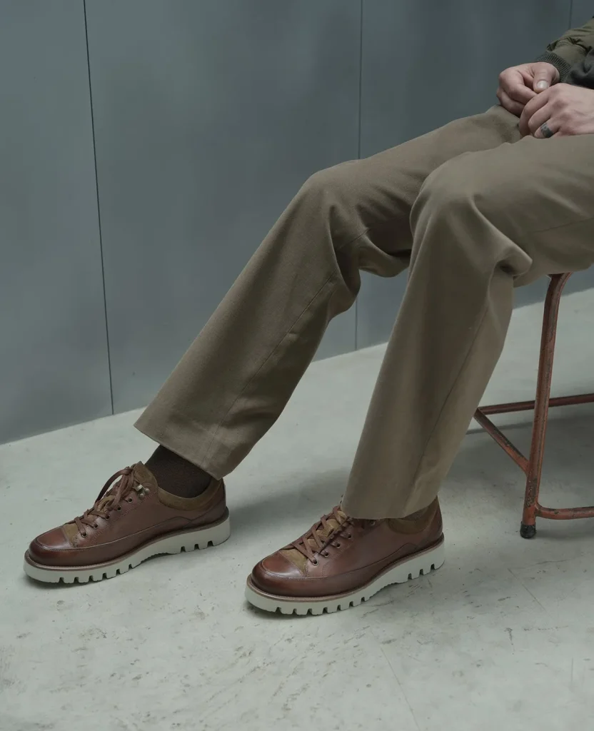 Brown leather lace-up shoes worn with stone trousers