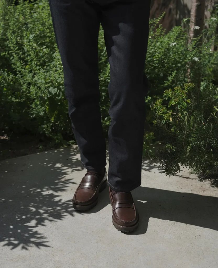 Brown leather footwear with dark trousers in the campaign courtyard