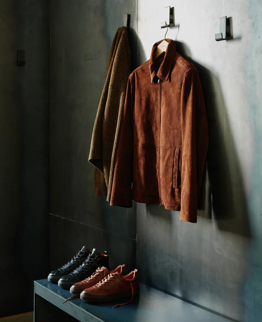 Brown jacket hanging above leather footwear