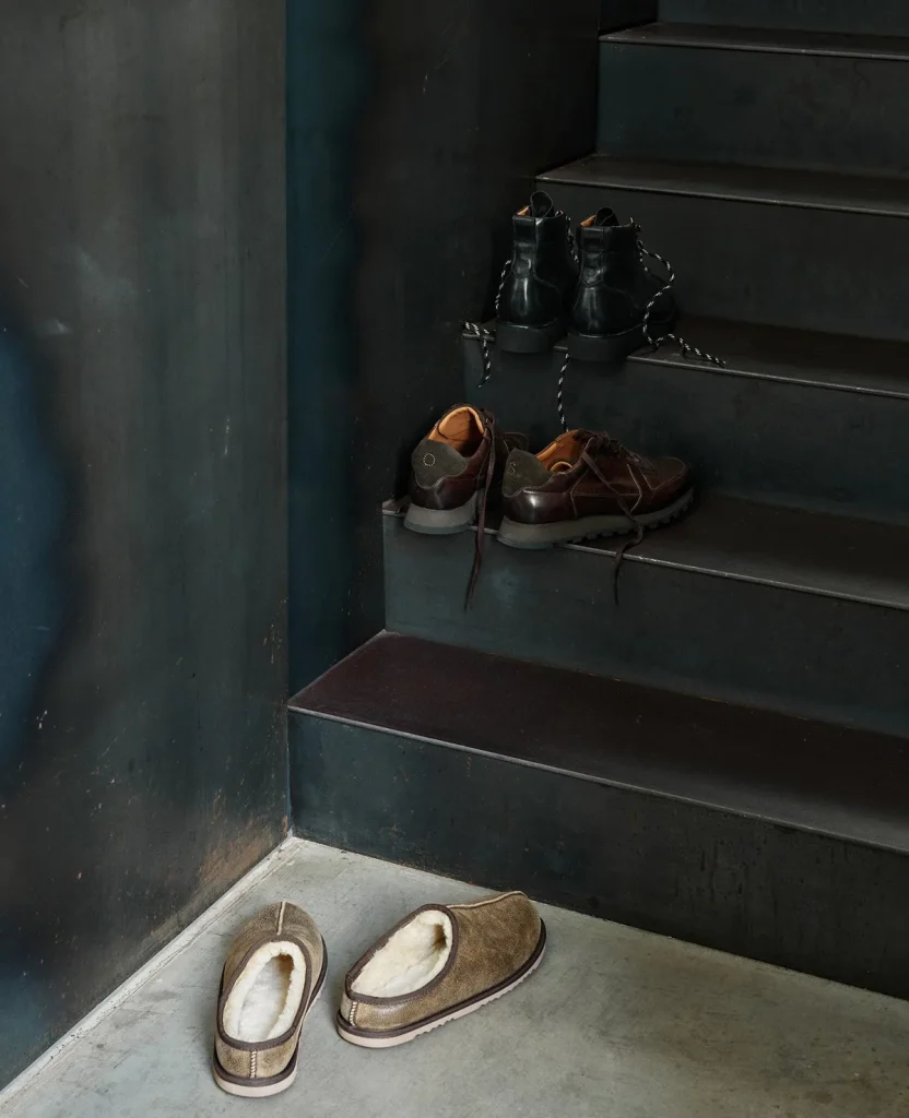 Leather footwear arranged on a dark staircase